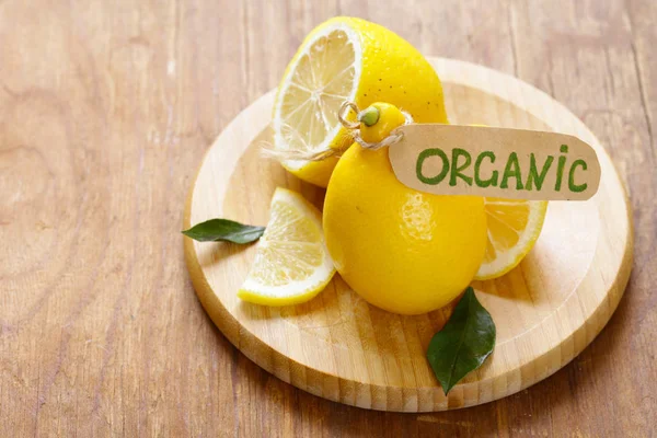 Natural organic yellow lemon on a wooden table — Stock Photo, Image