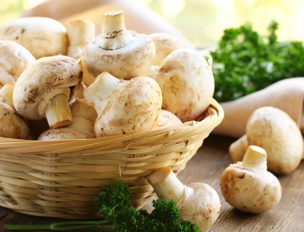 Champinhons de cogumelos crus orgânicos naturais em uma mesa de madeira — Fotografia de Stock