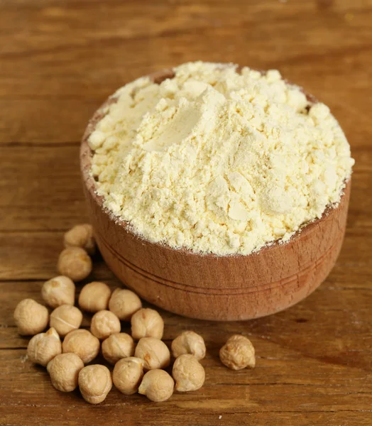 Natural organic chick pea flour in a wooden bowl — Stock Photo, Image