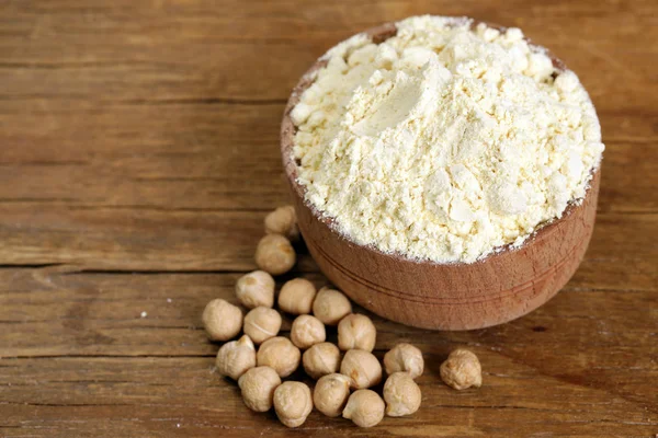 Natural organic chick pea flour in a wooden bowl — Stock Photo, Image