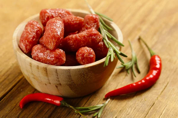 mini salami sausages on wooden table, organic product