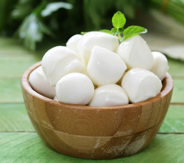 Mini mozzarella cheese in a wooden bowl — Stock Photo, Image