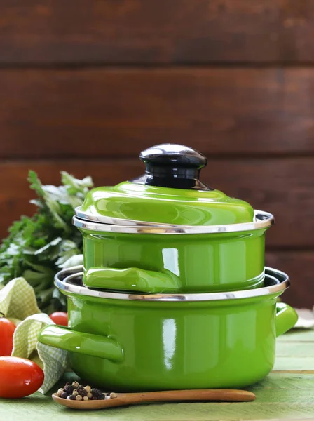 Cooking pot and ingredients for soup or stew on rustic background — Stock Photo, Image