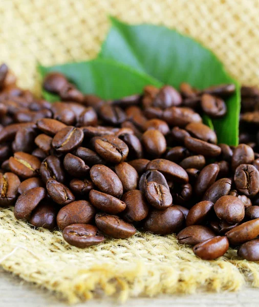 Natural organic coffee beans on a wooden background — Stock Photo, Image