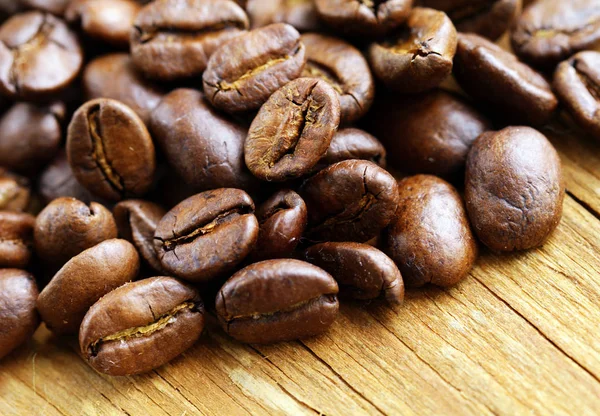 Natural organic coffee beans on a wooden background — Stock Photo, Image