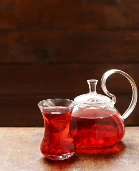 Fruit pomegranate tea in a teapot and cup — Stock Photo, Image