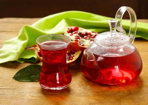 Fruit pomegranate tea in a teapot and cup — Stock Photo, Image