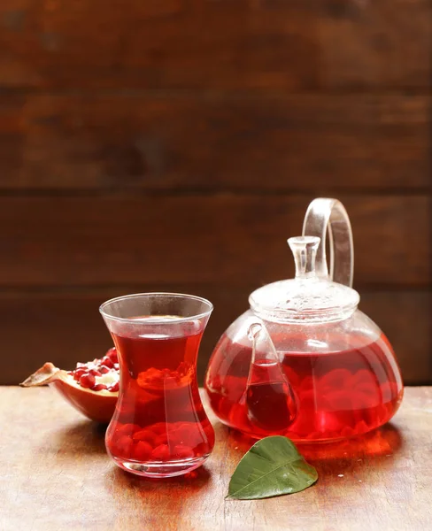 Fruit pomegranate tea in a teapot and cup — Stock Photo, Image