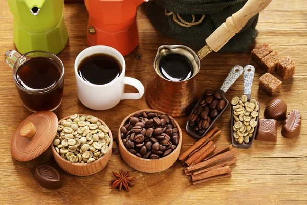 Still life of coffee - green and brown beans and spices, cinnamon and anise