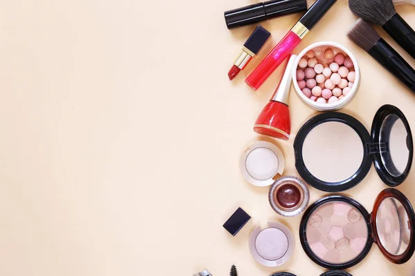 Set cosmetics - makeup brushes, eye shadow, powder, lipstick, nail polish.
