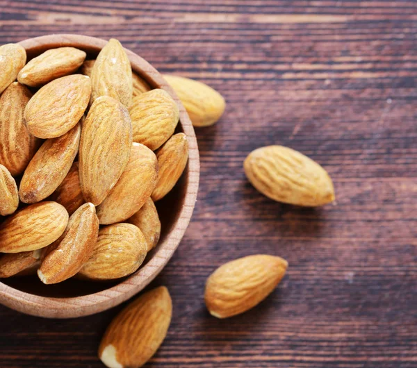 Organic peeled nuts almonds on a wooden background — Stock Photo, Image