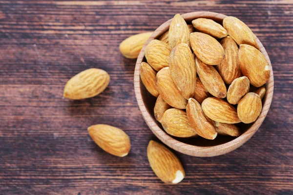 Organic peeled nuts almonds on a wooden background — Stock Photo, Image