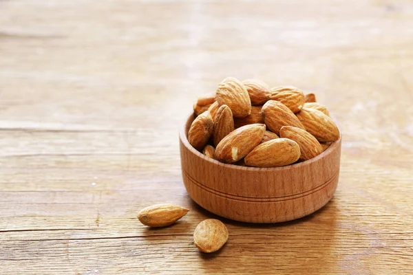 Organic peeled nuts almonds on a wooden background — Stock Photo, Image