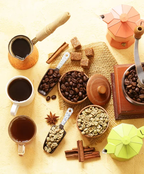 Still life of coffee - green and brown beans and spices, cinnamon and anise