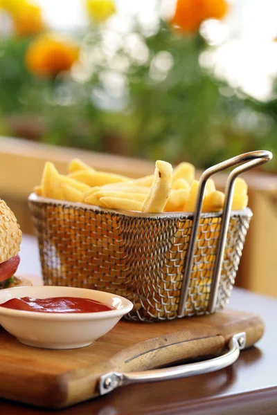 Traditional french fries with ketchup on a wooden table — Stock Photo, Image