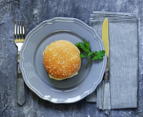 Fast food burger on a gray plate