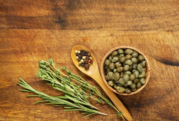 Marinated pickled capers on a wooden background — Stock Photo, Image