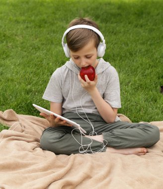 Genç yakışıklı yeşil çimenlerin üzerinde - yaz saati, piknik dinleniyor.