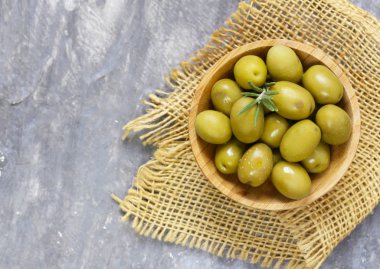 Ahşap bir masa üzerinde organik konserve yeşil zeytin