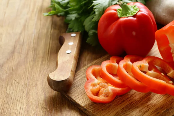 Sweet red pepper sliced on a wooden board, organic food — Stock Photo, Image
