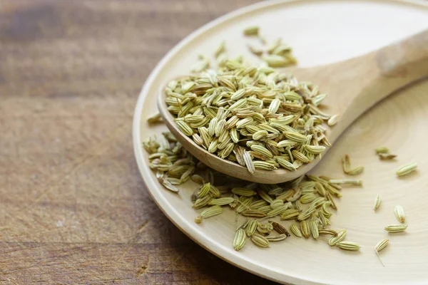 Spices fennel in a wooden spoon on a table — Stock Photo, Image
