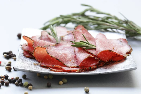 Salami pepperoni with aromatic pepper on a plate — Stock Photo, Image