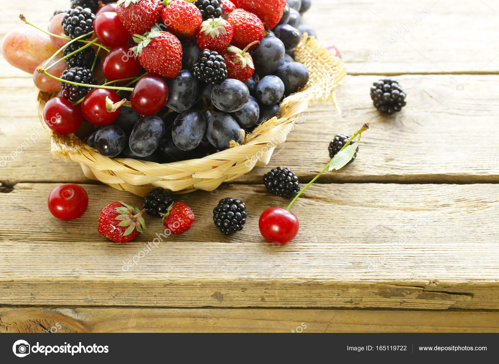 Summer harvest of berries raspberries, strawberries, grapes Stock