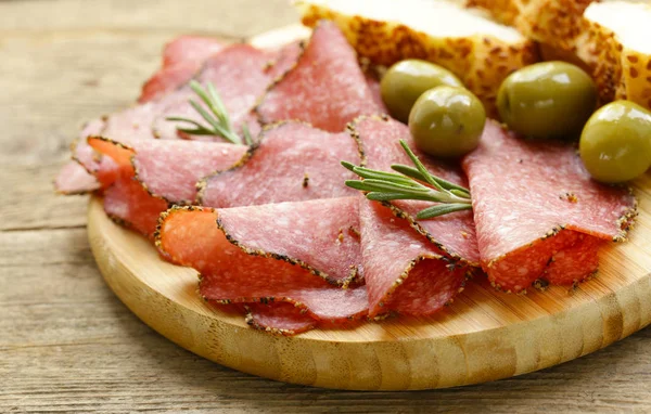 Salami pepperoni with aromatic pepper on a plate — Stock Photo, Image