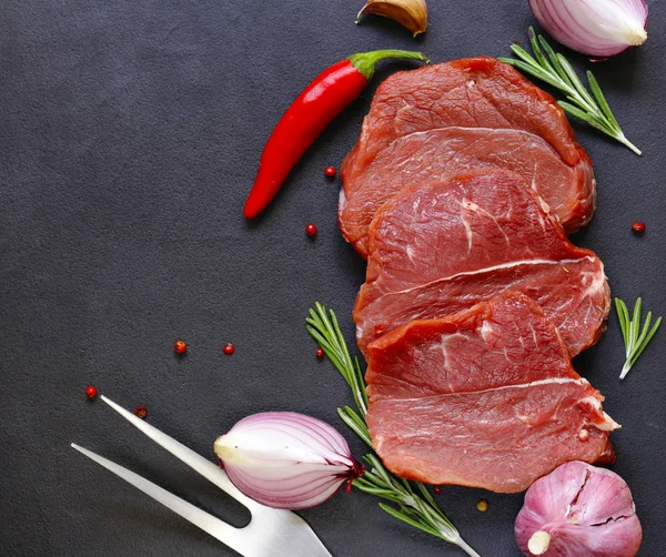 Raw meat, beef fillet on a black background — Stock Photo, Image