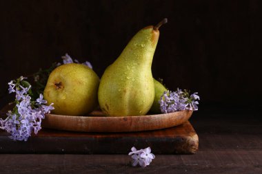 Tahta bir masada taze armutlar.