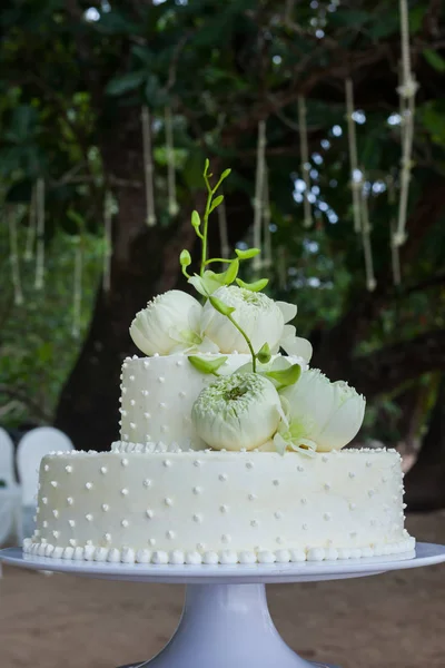 Svatební dort s květinami na vrcholu — Stock fotografie