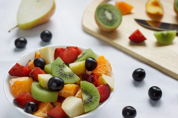 Desayuno saludable con kiwi, naranjas, ciruelas y otras frutas . — Foto de Stock