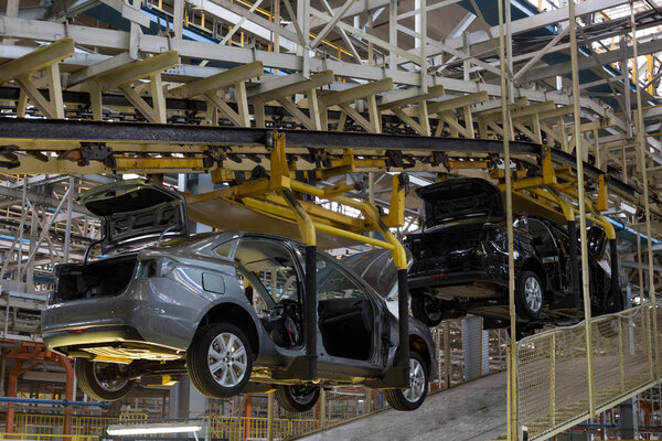 Russia, Izhevsk - December 14, 2019: LADA Automobile Plant Izhevsk, part of the AVTOVAZ Group. The new cars after painting on the conveyor line. Assembly shop of automobile plant.