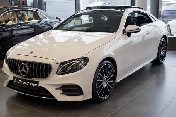 Russia, Izhevsk - February 20, 2020: New modern E-200 coupe in the Mercedes-Benz showroom. Famous world brand. Prestigious vehicles.