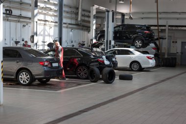 Russia, Izhevsk - April 21, 2018: Automobile workshop. Scheduled replacement of wheels and car repair in the workshop. Modern service.