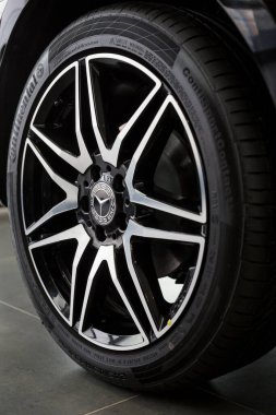 Russia, Izhevsk - February 20, 2020: Mercedes-Benz showroom. The wheel with alloy wheel of a new minivan V-Class. Premium brand. clipart