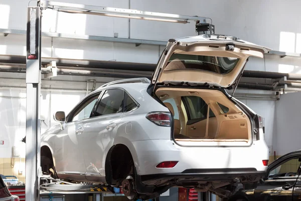 Scheduled replacement and wheel alignment in workshop car. Using a hydraulic lift.