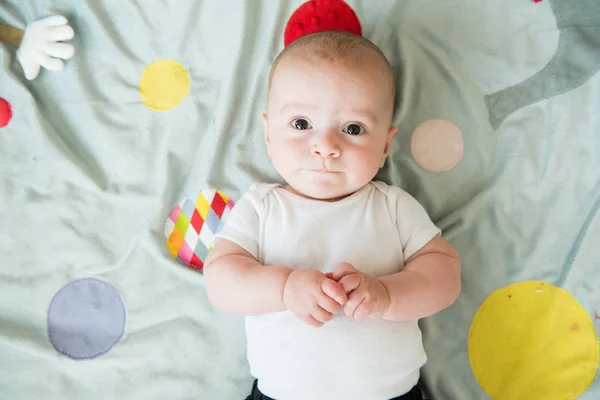 Overhead image of baby boy on playmat — Stock Photo, Image