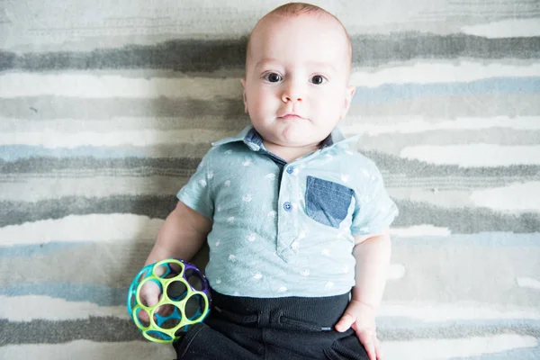 Baby Boy Blue Shirt Looks Camera While Laying Modern Striped — Stock Photo, Image