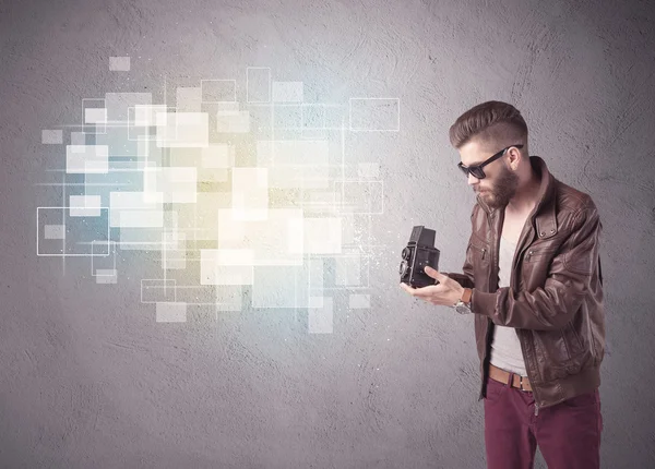 Hipster guy with retro camera in action — Stock Photo, Image