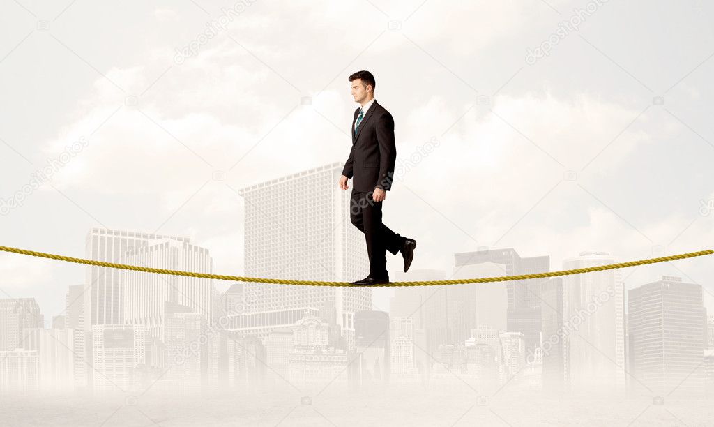 Business person balancing on golden rope