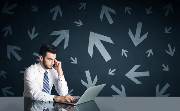 Businessman with arrows in background — Stock Photo, Image