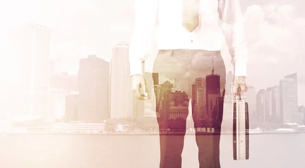 Businessman standing at cityscape background — Stock Photo, Image