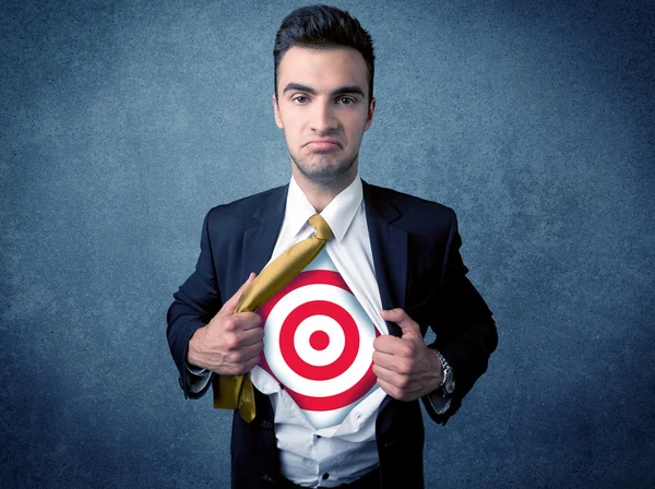 Businessman tearing shirt with target sign on his chest — Stock Photo, Image