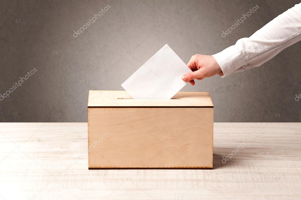 Ballot box with person casting vote 