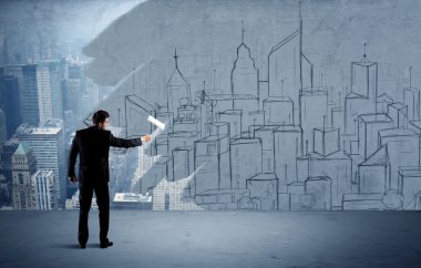 Zarif satıcı şehri duvarda yeniden boyuyor.