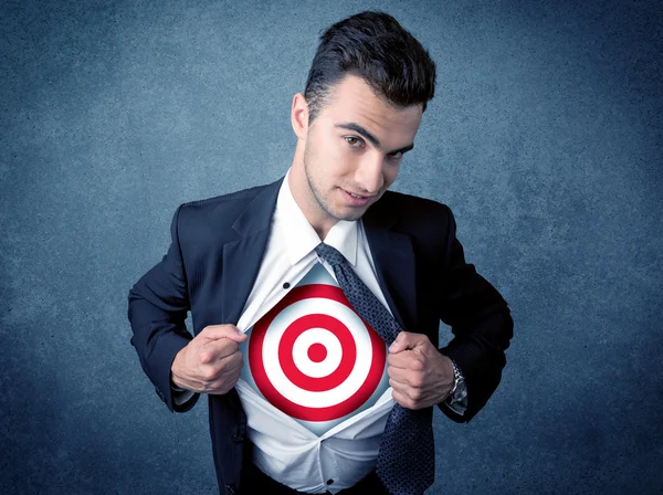 Businessman tearing shirt with target sign on his chest — Stock Photo, Image