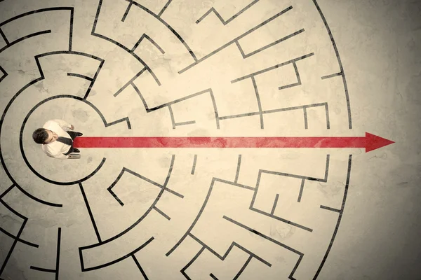 Business person standing in the middle of a circular maze — Stock Photo, Image