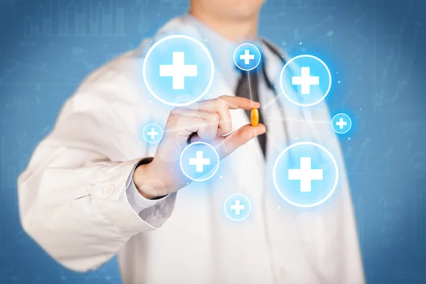 A doctor showing a pill with crosses — Stock Photo, Image