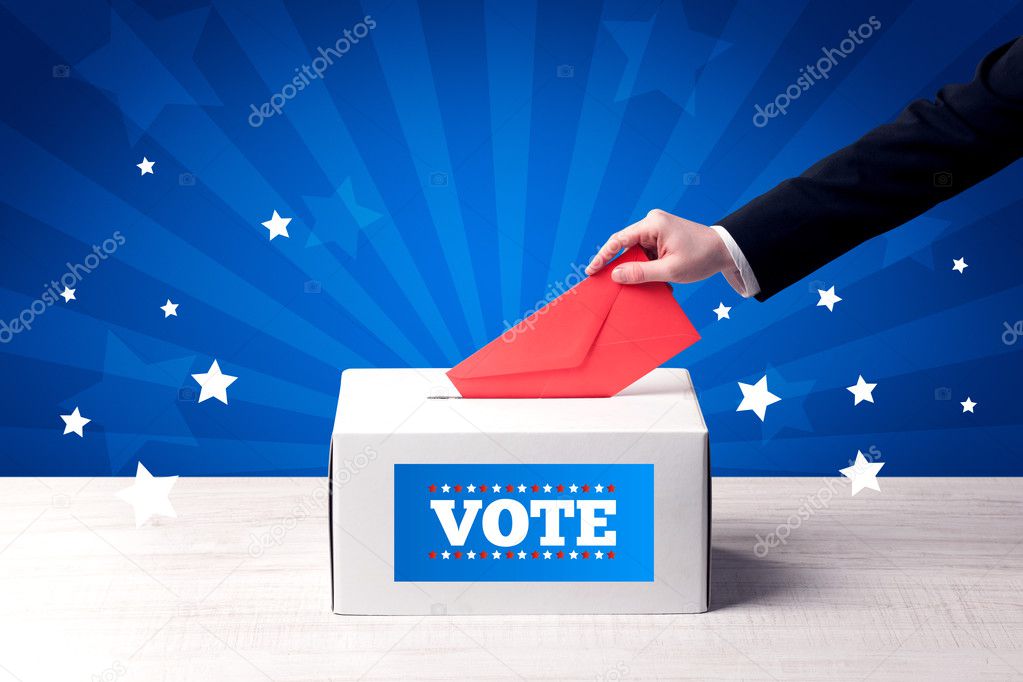 hand with ballot and wooden box